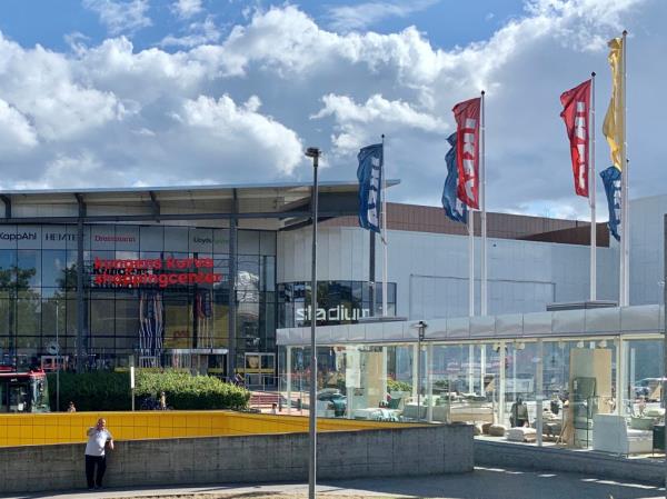 IKEA flags next to a shopping mall.