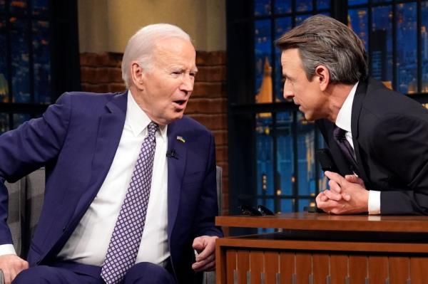 President Joe Biden talks with Seth Meyers during a taping of the 