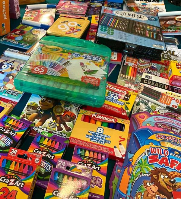 Teenager Eliza Liebowitz pushing a 'Courage Cart' filled with action figures, dolls, games, and art supplies destined for pediatric cancer patients at Memorial Sloan Kettering Cancer Center.