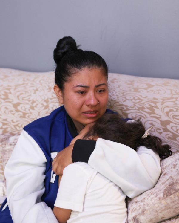 Mom holding her traumatized 2-year-old 10 days after attempted kidnapping.