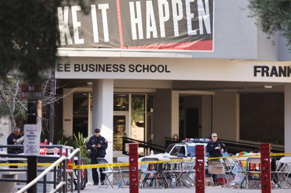 Police officers keeping watch outside Frank and Estella Beam Hall at UNLV campus following a tragic shooting incident.