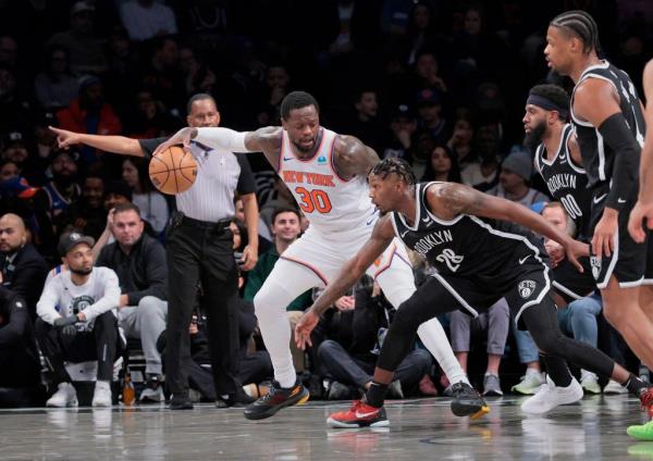 Dorian Finney-Smith #28 of the Brooklyn Nets tries to steal the ball from Julius Randle #30 of the New York Knicks