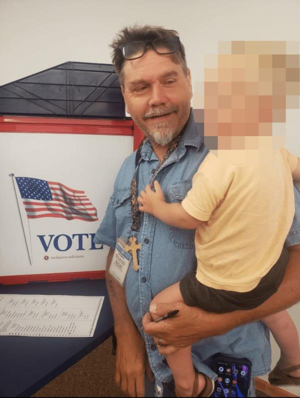 McClanahan is pictured voting with his son.
