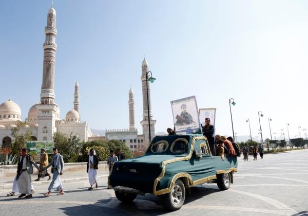 The Houthi movement's followers riding a vehicle carrying the coffin of Houthi fighters killed in recent attacks  during a funeral procession on January 18, 2024 in Sana'a, Yemen.
