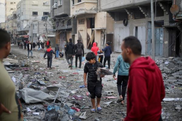 Palestinians inspect the site of Israeli strikes in Khan Younis in the southern Gaza Strip on Dec. 6, 2023. 