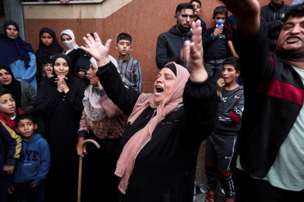 People react, as wounded Palestinians are brought into Nasser hospital, following Israeli strikes on Ma'an school east of Khan Younis in Khan Younis, in the southern Gaza Strip, on Dec. 5, 2023. 
