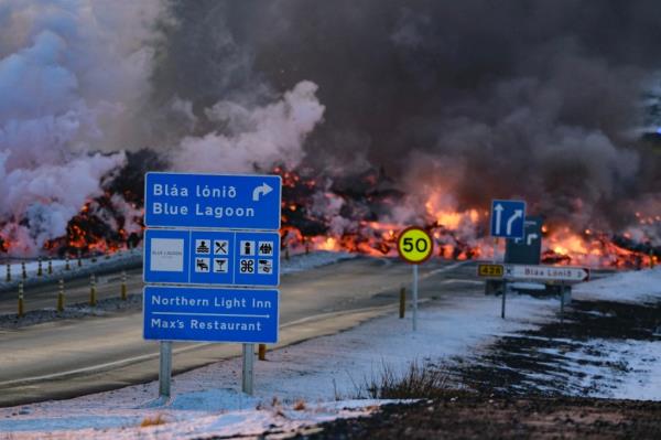 Molten lava overflowing a road, near Blue Lagoon in western Iceland, due to volcanic eruption on Reykjanes Peninsula in February 2023.