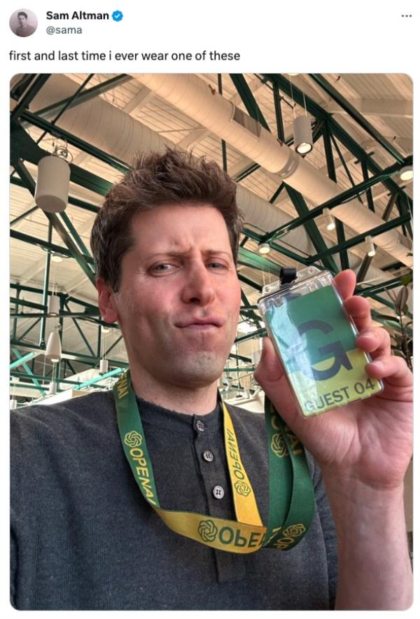 Sam Altman holding up a guest pass for OpenAI