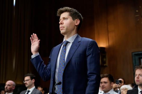 Altman raises his hand to be sworn in to give evidence to the Senate