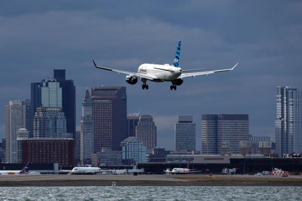 A file photo of a JetBlue  A JetBlue plane landing at Logan Internatio<em></em>nal Airport in Boston.