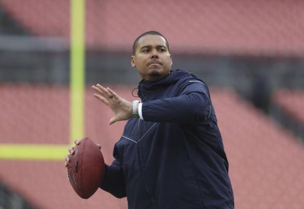 Bears general manager Ryan Poles throws a football on the field before the game on Dec. 17, 2023, at Cleveland Browns Stadium.=