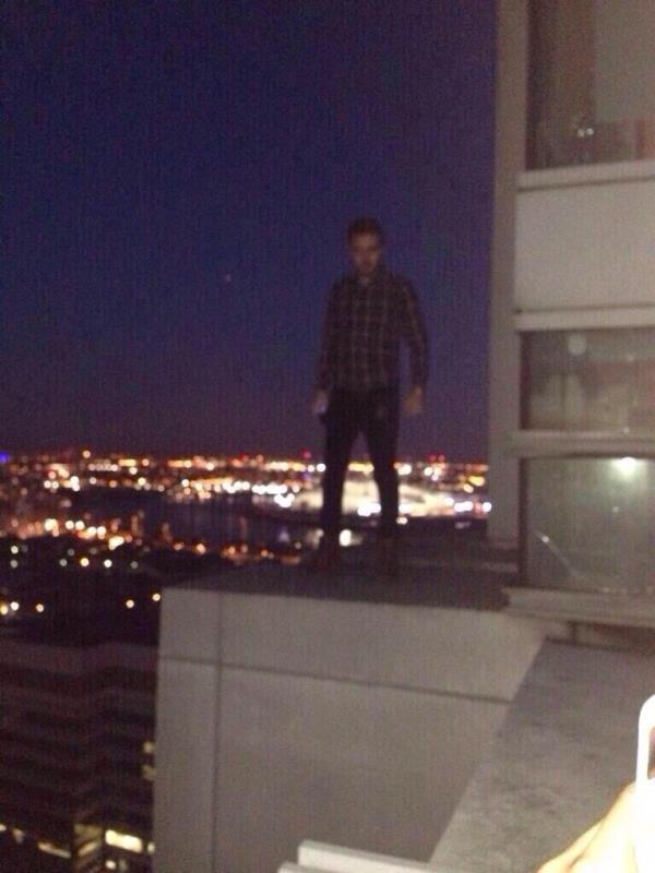 Liam Payne on the ledge next to his 35th floor balcony of his East Lo<em></em>ndon flat.