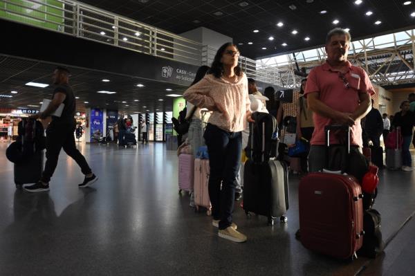 Passengers wait at airport.