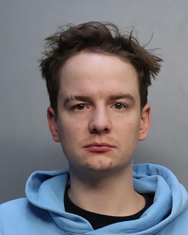 Brendon Paul in a blue hoodie in his official mugshot following his arrest on drug charges at Miami airport