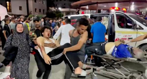 An injured person is taken into a hospital after hundreds of Palestinians were killed in a blast at Al-Ahli hospital in Gaza that Israeli and Palestinian officials blamed on each other in Gaza City, Gaza Strip, in this screen grab obtained from video October 17, 2023.  