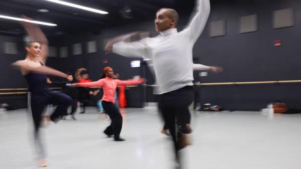 Rebekah Kuczat, left, dances with Mekeba Malik during rehearsals for Deeply Rooted Dance Theater performances on Oct. 13, 2023.