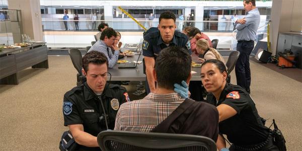 911 Lone Star's cast treating a patient who is seated in an office chair