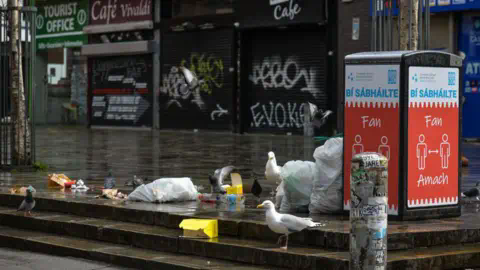 Getty Images A street in Dublin, there is a bin and rubbish on the floor, seagulls and pigeons are at the rubbish