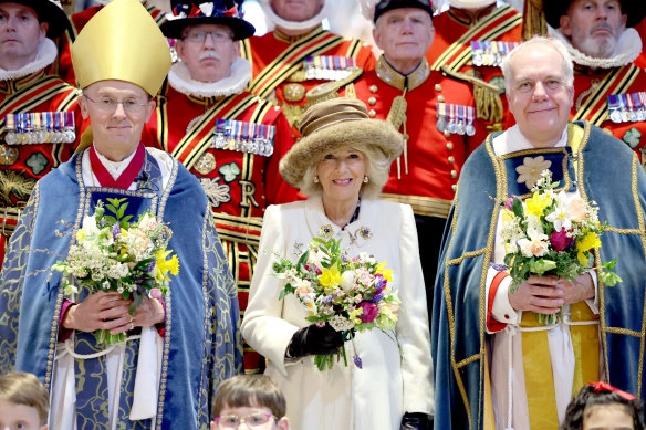 Queen Camilla holds a traditio<em></em>nal Nosegay bouquet as she poses with Yeomen of the Guard and and religious representatives during The Royal Maundy Service at Worcester Cathedral on March 28.