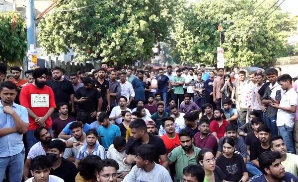 Students stage a protest over the death of three civil services aspirants after the ba<em></em>sement of a coaching centre was flooded following heavy rain.