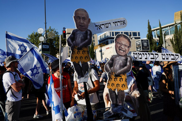 Protesters holding signs featuring Israeli Prime Minister Benjamin Netanyahu and Natio<em></em>nal Security Minister Itamar Ben-Gvir at demo<em></em>nstrations against the judicial overhaul.