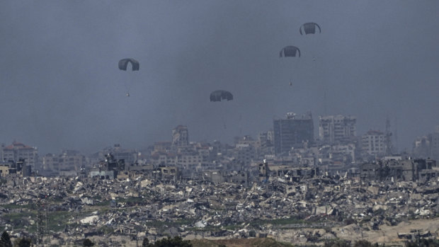 Gazans have many reasons to seek refuge. Parachutes dro<em></em>p supplies into the northern Gaza Strip, as seen from southern Israel on Wednesday. 